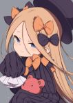  1girl abigail_williams_(fate/grand_order) bangs black_bow black_dress black_headwear blonde_hair blue_eyes blush bow commentary_request dress fate/grand_order fate_(series) forehead gamuo hair_bow hat highres long_hair long_sleeves looking_at_viewer orange_bow parted_bangs polka_dot polka_dot_bow simple_background sleeves_past_fingers sleeves_past_wrists solo stuffed_animal stuffed_toy teddy_bear very_long_hair 