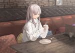  1girl cable_knit closed_eyes commentary_request cup grey_hair hair_between_eyes highres holding_drink idolmaster idolmaster_shiny_colors long_sleeves mug pillow plate polka_dot seisei_tamago sitting smile solo steam sweater table wooden_table yuukoku_kiriko 
