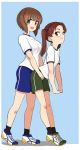  2girls aomushi_(mushamusha) black_legwear blue_background blue_shorts border breasts brown_eyes brown_hair commentary_request flat_chest full_body girls_und_panzer green_shorts gym_uniform highres kadotani_anzu long_hair looking_at_viewer medium_breasts multiple_girls nishizumi_miho shoes short_hair shorts simple_background sneakers socks standing twintails white_border 