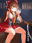  brown_hair crystal_ball detached_sleeves frown gohei hakurei_reimu mac_(dog_dog) ofuda red_eyes sitting solo table touhou 