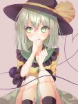  1girl artist_name bangs black_headwear black_legwear blush commentary_request eyebrows_visible_through_hair feet_out_of_frame frilled_shirt_collar frills green_eyes green_hair green_skirt grey_background hair_between_eyes hands_up hat hat_ribbon heart heart_of_string knees_up komeiji_koishi looking_to_the_side ribbon shiromoru_(yozakura_rety) shirt short_hair signature simple_background sitting skirt solo touhou yellow_ribbon yellow_shirt 