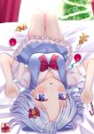  1girl bangs bed blue_dress blue_eyes blue_hair blush bow christmas christmas_ornaments christmas_present christmas_tree cirno curtains decorations dress forehead from_above gingerbread_man hair_ornament highres lying nibosisuzu on_back parted_bangs short_hair short_sleeves solo touhou upside-down 