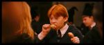  1boy 1girl bangs black_border black_eyes black_jacket black_neckwear blurry blurry_background border brown_hair chicken_(food) chicken_leg child eating food hands_up harry_potter hermione_granger holding indoors jacket long_hair long_sleeves necktie open_mouth orange_hair photo ron_weasley school_uniform screencap shirt solo_focus upper_body white_shirt 