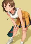  1girl alternate_costume bangs banned_artist blush breasts brown_eyes brown_hair character_name cheerleader clothes_writing hands_on_own_knees hiryuu_(kantai_collection) kantai_collection makio_(makiomeigenbot) shadow shoes short_hair simple_background skirt sleeveless sneakers socks solo white_footwear white_legwear yellow_background yellow_skirt 