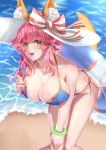  1girl absurdres animal_ear_fluff animal_ears bikini blue_bikini breasts cleavage collarbone ears_through_headwear eyebrows_visible_through_hair fate/grand_order fate_(series) fox_ears fox_girl fox_tail hat highres innertube kamehito large_breasts looking_at_viewer ocean open_mouth outdoors pink_hair ribbon side-tie_bikini solo sun_hat swimsuit tail tamamo_(fate)_(all) tamamo_no_mae_(swimsuit_lancer)_(fate) yellow_eyes 