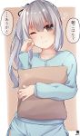  1girl absurdres blue_shirt blue_shorts blush brown_background brown_eyes eyebrows_visible_through_hair grey_hair hair_between_eyes hair_ribbon hibiki_zerocodo highres holding holding_pillow kantai_collection kasumi_(kantai_collection) long_hair long_sleeves looking_at_viewer pillow ribbon shirt short_shorts shorts side_ponytail sleepwear solo translation_request two-tone_background white_background 