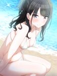  1girl absurdres beach bikini black_hair blue_eyes blush breasts cleavage closed_mouth collarbone day frown half_updo highres idolmaster idolmaster_shiny_colors kazano_hiori long_hair looking_at_viewer mole mole_under_mouth musha_no_kozi navel ocean outdoors ponytail sand sitting small_breasts solo swept_bangs swimsuit water white_bikini 