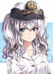  1girl alternate_costume bangs blue_eyes breasts eyebrows_visible_through_hair female_service_cap hair_between_eyes hat highres kantai_collection kashima_(kantai_collection) kuroi_mimei long_hair medium_breasts military military_uniform shirt short_sleeves silver_hair simple_background smile solo twintails two-tone_background uniform upper_body wavy_hair white_headwear white_shirt 