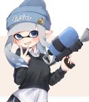 1girl bangs beanie black_shorts blue_headwear blunt_bangs blunt_ends brown_sweater clothes_writing collared_shirt commentary dolphin_shorts domino_mask fang grey_background grey_eyes grey_hair hat highres holding holding_weapon inkling letterboxed logo long_hair long_sleeves looking_at_viewer mask octoshot_(splatoon) open_mouth pointy_ears print_headwear shirt short_shorts shorts skin_fang smile solo splatoon_(series) sweater symbol_commentary tentacle_hair v weapon white_shirt yuzutouhu_ika 