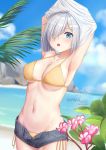  1girl arms_up bangs beach bikini blue_eyes blush breasts cleavage cloud day denim denim_shorts flower hair_ornament hair_over_one_eye hairclip hamakaze_(kantai_collection) highres kantai_collection large_breasts ocean open_mouth outdoors pink_flower plant short_hair short_shorts shorts side-tie_bikini signature silver_hair sky skyrail solo swimsuit swimsuit_under_clothes undressing watermark yellow_bikini 