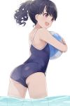  1girl ass ball bangs bare_arms bare_shoulders beachball black_hair blue_swimsuit commentary_request curly_hair eyebrows_visible_through_hair fangs from_behind fukumaru_koito highres hiroki_(yyqw7151) idolmaster idolmaster_shiny_colors object_hug one-piece_swimsuit open_mouth ponytail purple_eyes skin_fangs solo swimsuit wading water wet white_background 