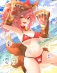  1girl animal_ear_fluff animal_ears armpits bangs beach bell bell_collar bikini breasts cleavage collar day eyebrows_visible_through_hair fangs fate/grand_order fate_(series) fox_ears fox_tail gloves highres jingle_bell kneeling leyu long_hair looking_at_viewer medium_breasts navel open_mouth outdoors paw_gloves paw_shoes paws pink_hair ponytail red_bikini shoes solo swimsuit tail tamamo_(fate)_(all) tamamo_cat_(fate) yellow_eyes 