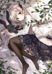  1girl black_legwear black_skirt blonde_hair brown_eyes clothing_request fetal_position flower flower_request frilled_skirt frills highres kikistark leaf long_hair looking_at_viewer on_ground original pantyhose skirt stuffed_animal stuffed_toy twintails very_long_hair 