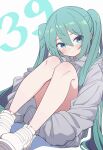  1girl 39 absurdres aqua_hair blue_eyes blush closed_mouth commentary full_body grey_hoodie hair_between_eyes hatsune_miku highres hiroikara_(smhong04) hood hoodie hugging_own_legs long_hair long_sleeves looking_at_viewer miku_day shadow shoes simple_background sitting smile sneakers solo twintails very_long_hair vocaloid white_background wide_sleeves 
