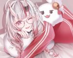  artist_name bed_sheet blurry blurry_background braid commentary_request cray glasses gradient_hair hair_between_eyes hololive looking_at_viewer low_twin_braids lying multicolored_hair nakiri_ayame nakiri_ayame_(off-work) on_stomach one_eye_closed open_mouth pillow poyoyo_(nakiri_ayame) red_eyes red_hair red_track_suit streaked_hair twin_braids virtual_youtuber white_hair 