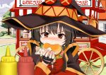  1girl bangs black_cape black_gloves black_hair black_headwear blurry blurry_foreground blush cape commentary_request day depth_of_field dress eyebrows_visible_through_hair fingerless_gloves food gibun_(sozoshu) gloves hamburger hand_up hat highres holding holding_food ketchup_bottle kono_subarashii_sekai_ni_shukufuku_wo! long_hair long_sleeves megumin mustard_bottle nose_blush outdoors red_dress red_eyes sidelocks solo v-shaped_eyebrows vending_cart witch_hat 