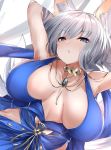  1girl animal_ears arms_behind_head azur_lane bangs bare_shoulders blue_dress blue_eyes breasts cleavage commentary_request dress eyebrows_visible_through_hair eyeliner fox_ears fox_girl fox_tail jewelry kaga_(azur_lane) kitsune kyuubi large_breasts long_hair makeup multiple_tails mutou_(94753939) necklace parted_lips silver_hair tail 