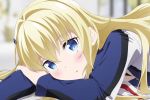  1girl blonde_hair blue_eyes blurry blurry_background blush claudia_bruford close-up hair_ornament hairclip head_rest highres jacket long_hair long_sleeves looking_at_viewer lying official_art on_stomach senyoku_no_sigrdrifa solo upper_body 