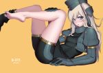  1girl artist_name bangs barefoot bike_shorts black_swimsuit blonde_hair blue_eyes blush breasts character_name cropped_jacket garrison_cap hat headgear highres kantai_collection long_hair nanja parted_lips puffy_sleeves simple_background small_breasts solo swimsuit thighs u-511_(kantai_collection) yellow_background 