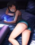  1girl black_hair cellphone commentary denim denim_shorts grin hashi lying on_bed on_side original phone purple_eyes short_hair short_shorts shorts smartphone smile solo tank_top upshorts 