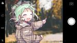  1girl adan_imas bangs blurry blurry_background blush camera cellphone cellphone_camera closed_eyes commentary dot_nose fang green_hair hair_bun hololive long_sleeves open_mouth outdoors path phone plaid plaid_jacket pointing short_hair short_hair_with_long_locks smile solo taking_picture tree upper_body uruha_rushia virtual_youtuber 