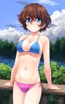  1girl akaboshi_koume aposine artist_name bikini blue_eyes breasts brown_hair bush closed_mouth cloud collarbone commentary cowboy_shot english_commentary eyebrows_visible_through_hair girls_und_panzer hair_between_eyes highres looking_at_viewer medium_breasts mismatched_bikini navel railing short_hair side-tie_bikini signature sky smile solo standing swimsuit water 