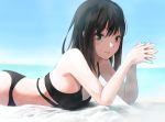  1girl bangs beach bikini black_bikini black_hair blurry blurry_background breasts cleavage closed_mouth day eyebrows_visible_through_hair green_eyes hair_between_eyes highres idolmaster idolmaster_cinderella_girls k_concord long_hair looking_at_viewer lying ocean on_stomach outdoors shibuya_rin small_breasts smile solo straight_hair swimsuit 