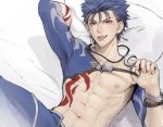  1boy abs bangs bed_sheet blue_hair blue_pants chest chest_tattoo collarbone commentary_request crescent crescent_moon_pin cu_chulainn_(fate)_(all) earrings fang fate/stay_night fate_(series) highres jewelry lancer looking_at_viewer lying male_focus mondi_hl naughty_face navel nipples on_back open_mouth pants pillow red_eyes smile solo tattoo tongue tongue_out upper_body 