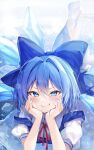  1girl absurdres blue_bow blue_dress blue_eyes blue_hair blush bow cirno clenched_teeth commentary_request dress hair_between_eyes hair_bow hands_on_own_cheeks hands_on_own_face highres ice ice_wings looking_at_viewer lying neck_ribbon nenobi_(nenorium) on_stomach red_ribbon ribbon shirt smile snowflakes socks solo teeth touhou white_shirt white_socks wings 