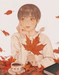  1girl arm_support book brown_eyes brown_hair chin_rest cup falling_leaves highres leaf looking_to_the_side maple_leaf original sano_namu saucer sepia short_hair simple_background 