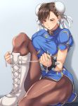  1girl black_mutou blue_background blue_dress blush boots bracelet breasts brown_eyes brown_hair brown_legwear bun_cover china_dress chinese_clothes chun-li cross-laced_footwear double_bun dress earrings gradient gradient_background jewelry lips medium_breasts pantyhose pelvic_curtain puffy_short_sleeves puffy_sleeves sash shadow shoelaces short_sleeves sitting solo spiked_bracelet spikes street_fighter white_footwear 