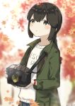  1girl autumn_leaves black_eyes black_hair braid camera clothes_writing commentary_request green_jacket hair_between_eyes holding holding_camera isonami_(kantai_collection) jacket kantai_collection low_twintails official_alternate_costume sidelocks solo twin_braids twintails upper_body yamashichi_(mtseven) 