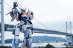 baselard_(frame_arms) blurry blurry_background bridge clenched_hand frame_arms green_eyes looking_at_viewer mecha model_kit no_humans open_hand photo_(medium) solo suzu_(garage516) waving 