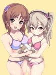  2girls blush boko_(girls_und_panzer) breasts brown_hair cleavage closed_mouth collarbone eyebrows_visible_through_hair girls_und_panzer highres holding holding_stuffed_toy kasai_shin large_breasts looking_at_viewer medium_breasts medium_hair multiple_girls nishizumi_miho open_mouth shimada_arisu short_hair side_ponytail simple_background smile stuffed_animal stuffed_toy teddy_bear yellow_background 