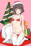  1girl alternate_costume bangs bare_arms bare_shoulders bikini blunt_bangs blush box breasts brown_eyes brown_hair choker christmas christmas_ornaments christmas_tree eyebrows_visible_through_hair fur_trim gift gift_box hat high_heels highres kantai_collection kishinami_(kantai_collection) kumadano looking_at_viewer navel open_mouth red_bikini sack santa_bikini santa_costume santa_hat short_hair side-tie_bikini small_breasts smile solo swimsuit symbol_commentary thighhighs wavy_hair white_legwear 