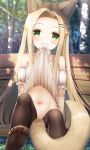  1girl animal_ear_fluff animal_ears bare_shoulders black_legwear blonde_hair blush dress dress_lift forehead green_eyes highres lifted_by_self long_hair looking_at_viewer mouth_hold navel original outdoors psyche3313 sitting smile solo tail thighhighs 