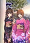  2girls bangs black_kimono blue_sky blush brown_eyes brown_hair closed_eyes closed_mouth commentary dawn eyebrows_visible_through_hair floral_print furisode girls_und_panzer gradient_sky hatsumoude highres horizon japanese_clothes kakimoto_nao kimono long_sleeves looking_at_another multiple_girls new_year nishizumi_maho nishizumi_miho obi open_mouth orange_sky outdoors pink_kimono print_kimono sash short_hair siblings sisters sky smile standing tree v_arms wide_sleeves 