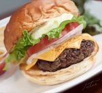  blurry blurry_background bread bread_bun cheese food food_focus hamburger igaiga_(igarashijunji) lettuce meat no_humans onion original photorealistic plate signature simple_background still_life tomato tomato_slice vegetable 