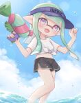  1girl :d bangs black_shorts blue_headwear blue_sky blunt_bangs blunt_ends clothes_writing cloud cloudy_sky commentary day dolphin_shorts domino_mask droplet english_commentary eyebrows_visible_through_hair fang green_hair highres holding holding_weapon inkling inkling_(language) long_hair looking_at_viewer mask midriff navel open_mouth outdoors pioxpioo pointy_ears purple_eyes shirt short_shorts shorts skin_fang sky smile solo splatoon_(series) splatoon_2 splattershot_(splatoon) standing t-shirt tentacle_hair tied_shirt visor_cap w_arms wading water weapon white_shirt 