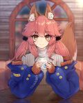  1girl absurdres alternate_hairstyle animal_ear_fluff animal_ears artist_name artist_request chaldea_logo character_name closed_mouth coffee eyebrows_visible_through_hair fang fate/extra fate/grand_order fate_(series) fox_ears fox_girl fox_tail highres indoors looking_at_viewer off-shoulder_sweater off_shoulder pink_hair skin_fang solo sweater tail tamamo_(fate)_(all) tamamo_no_mae_(fate) twintails yellow_eyes 