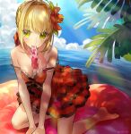  1girl ahoge akamakoto bangs bare_shoulders blonde_hair blue_sky blush braid breasts cleavage collarbone dress fate/grand_order fate_(series) flower french_braid green_eyes hair_between_eyes hair_bun hair_flower hair_intakes hair_ornament kneeling large_breasts long_hair looking_at_viewer mouth_hold nero_claudius_(fate)_(all) nero_claudius_(swimsuit_caster)_(fate) ocean red_dress short_dress sky thighs 