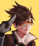  1girl black_gloves brown_coat brown_eyes brown_hair closed_mouth coat eyelashes gloves goggles looking_at_viewer orange-tinted_eyewear overwatch portrait redsakaone salute short_hair simple_background smile solo tinted_eyewear tracer_(overwatch) two-finger_salute yellow_background 