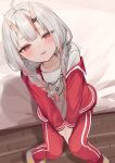  1girl absurdres ahoge bed braid from_above grey_hair highres hololive horns iruka3 jacket looking_at_viewer nakiri_ayame official_alternate_costume oni open_clothes open_jacket open_mouth pants red_eyes shirt sitting smile solo t-shirt track_jacket track_pants twin_braids virtual_youtuber white_shirt 