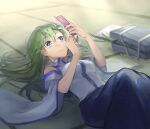  1girl bag bare_shoulders blue_eyes blue_skirt breasts cellphone closed_mouth detached_sleeves expressionless eyebrows_visible_through_hair feet_out_of_frame flip_phone green_hair highres holding holding_phone indoors knees_up kochiya_sanae looking_at_phone lying medium_breasts notebook on_back pen phone reflective_eyes school_bag shidaccc shirt skirt solo tatami touhou white_shirt wide_sleeves 