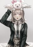  1girl arm_up bangs black_jacket black_shirt breasts brown_hair collared_shirt danganronpa_(series) danganronpa_2:_goodbye_despair dress_shirt ear_bow flipped_hair frilled_skirt frills grey_background hair_ornament hairclip highres hood jacket looking_up medium_breasts medium_hair muuyiie nanami_chiaki on_head on_person open_clothes open_jacket pink_eyes pink_skirt shiny shiny_hair shirt shirt_tucked_in sitting skirt symbol_commentary two-tone_shirt usami_(danganronpa) wings 