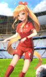  1girl :d ball blonde_hair blue_sky blush bow cloud fc_bayern_munchen field green_eyes hair_bow highres kerno long_hair looking_at_viewer open_mouth original outdoors ponytail red_bow red_legwear red_shirt red_shorts shirt short_sleeves shorts sky smile soccer_ball soccer_uniform socks solo sportswear stadium standing 
