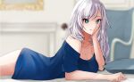  1girl alternate_costume aqua_eyes bangs blanc_(studio_artblock) blue_shirt blurry blurry_background breasts cleavage collarbone english_commentary eyebrows_visible_through_hair hand_on_head hololive hololive_indonesia lying no_pants off-shoulder_shirt off_shoulder on_bed on_stomach pavolia_reine shirt silver_hair smile solo virtual_youtuber 
