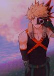  1boy bakugou_katsuki bangs bare_shoulders belt black_gloves black_pants black_shirt black_sleeves blonde_hair boku_no_hero_academia camera closed_mouth collarbone detached_sleeves english_commentary expressionless field gloves grass hair_ornament hand_in_pocket hand_up holding holding_camera male_focus one_eye_closed outdoors pants red_gloves shirt short_hair sleeveless solo spiked_hair two-tone_gloves wengwengchim 