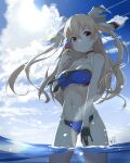  1girl beach bikini black_gloves blue_swimsuit breasts brown_eyes choker cloud cloudy_sky day eyebrows_visible_through_hair gloves hair_between_eyes hair_ribbon ice_cream_cone johnston_(kancolle) kantai_collection light_brown_hair long_hair looking_at_viewer medium_breasts navel neve ocean partially_submerged ribbon signature single_glove sky solo standing sun swimsuit two_side_up water 