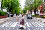  1girl abbey_road aqua_eyes brown_footwear brown_hair building car chutohampa crosswalk grey_shirt ground_vehicle high_heels long_hair motor_vehicle open_mouth original plant purple_skirt road sandals shadow shirt shirt_tucked_in short_sleeves signature skirt smile solo street tree walking window 